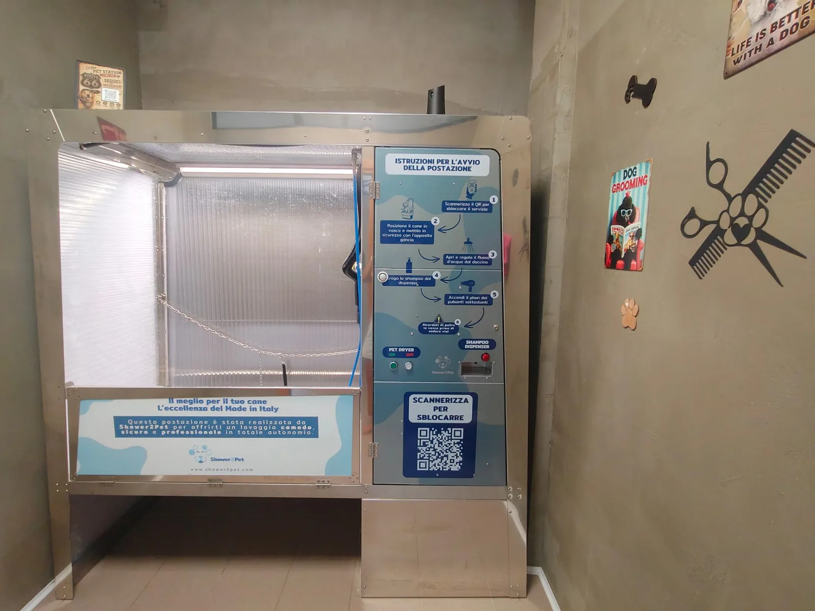Postazione self-service Shower2Pet Akita installata in un locale, con vasca rialzata, doccetta e phon